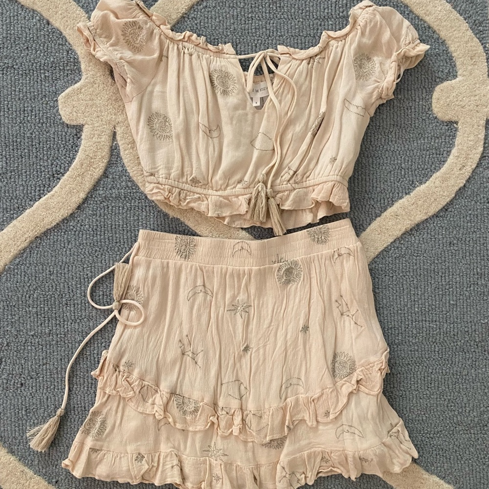 Two piece ivory set. “Free the roses” brand. Size small